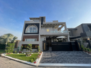 Exterior view of house for sale in Bahria Town Lahore, near schools, shops, mosque, and hospital, featuring modern design and safe community.